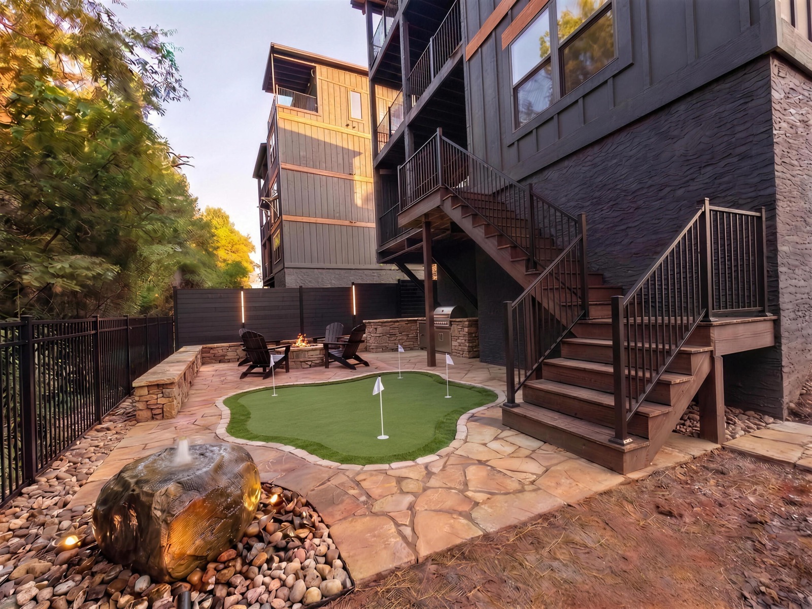Photoreal design rendering of a finished backyard with a putting green between two cabins