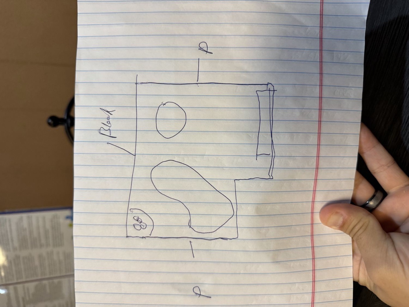 Hand-drawn pen sketch of the backyard layout on a legal pad