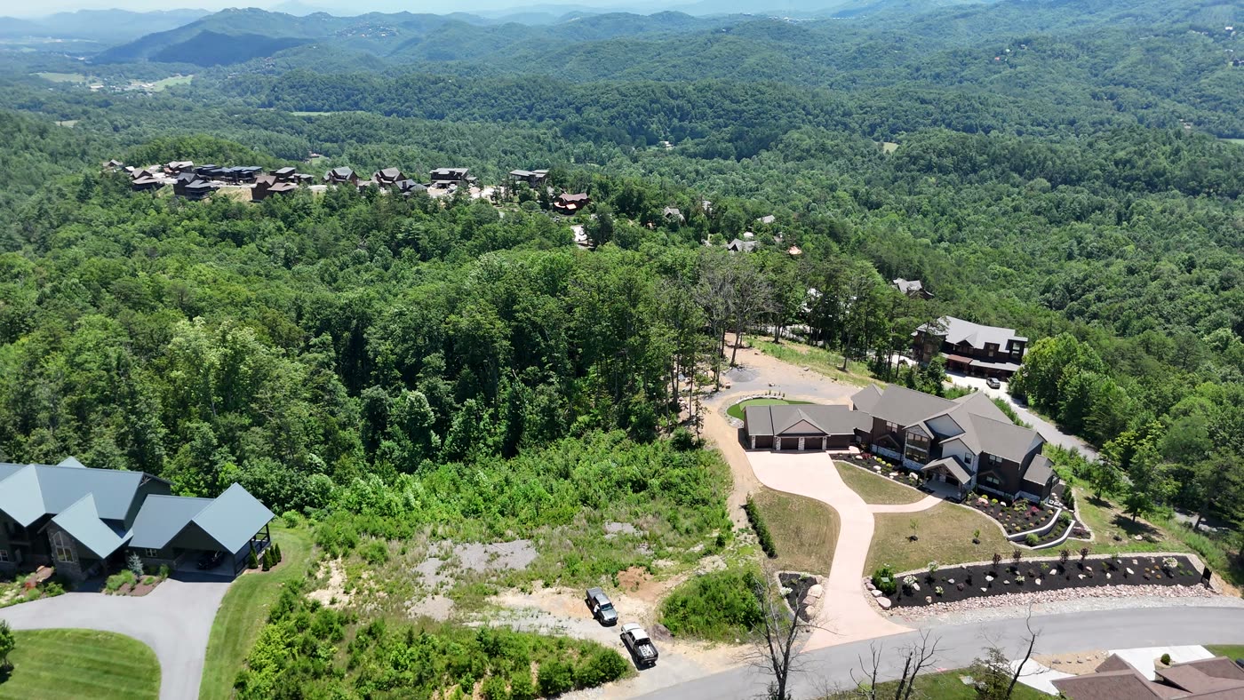 Aerial view of a wooded East Tennessee property with structures among the trees