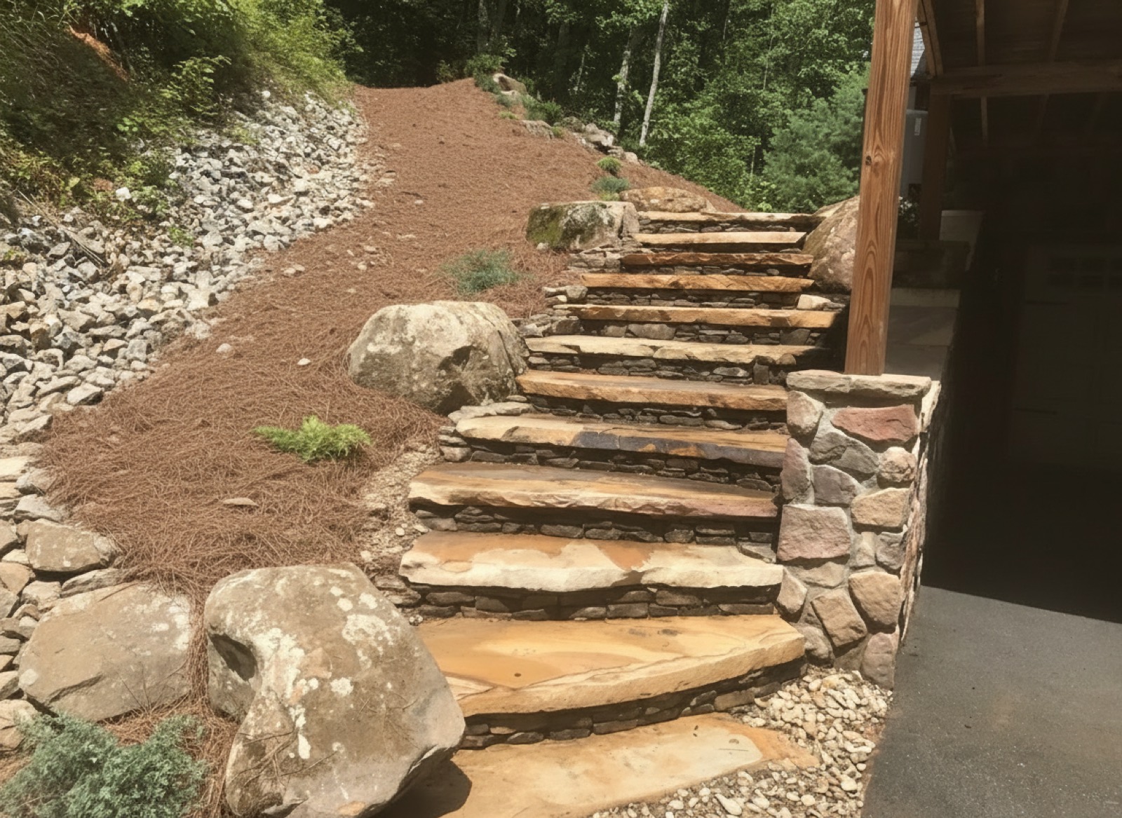 Hand-set natural stone steps carrying a landscaped slope